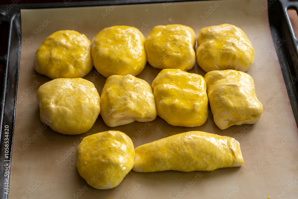 Raw buns on a baking sheet. Baking bread. Food concept Raw buns on a baking sheet. Baking bread. Food concept