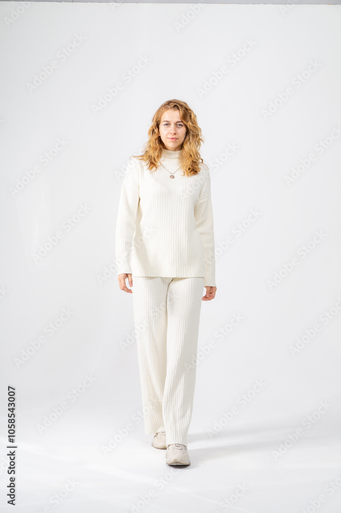Cute young blonde girl posing standing on white background, copy space Cute young blonde girl posing standing on white background, copy space
