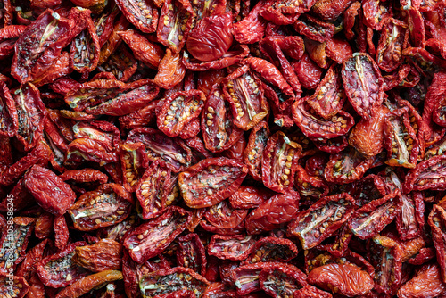 Sun dried red tomato, top view, closeup. Background and texture of dried red tomatoes