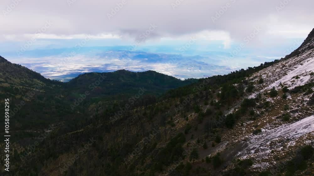 Aerial approaching shot of National park in Mexico. Snowy peak of mountains in Nevado de Colima, Jalisco. Wide shot. Aerial approaching shot of National park in Mexico. Snowy peak of mountains in Nevado de Colima, Jalisco. Wide shot.