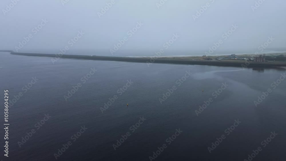 Aerial panning of Little Haven Beach, North and South Piers in thick fog. South Shields, UK Aerial panning of Little Haven Beach, North and South Piers in thick fog. South Shields, UK