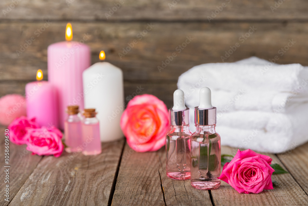 Rose essential oil on a textured background.Roses and a bottle of rose perfumed water.Aromatherapy treatment. Beauty concept. Spa procedure.Natural organic oil.Anti-stress,detox relax.Place for text Rose essential oil on a textured background.Roses and a bottle of rose perfumed water.Aromatherapy treatment. Beauty concept. Spa procedure.Natural organic oil.Anti-stress,detox relax.Place for text