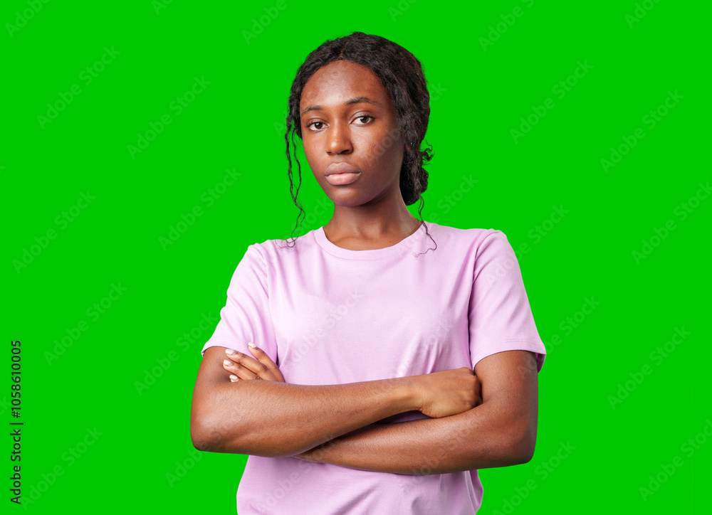 Young woman with an expression of contemplation poses against a bright green background Young woman with an expression of contemplation poses against a bright green background