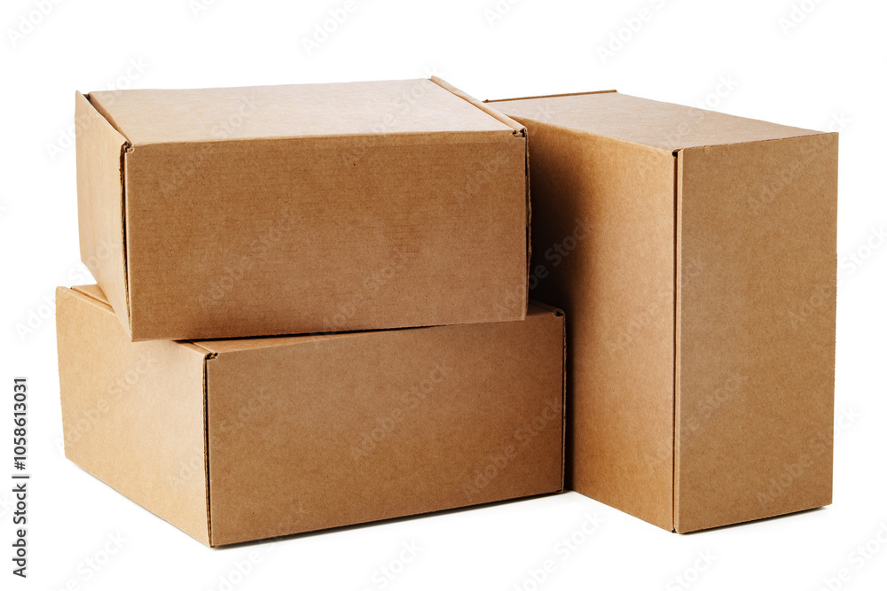 Stacked brown cardboard boxes in various sizes arranged on a white background Stacked brown cardboard boxes in various sizes arranged on a white background