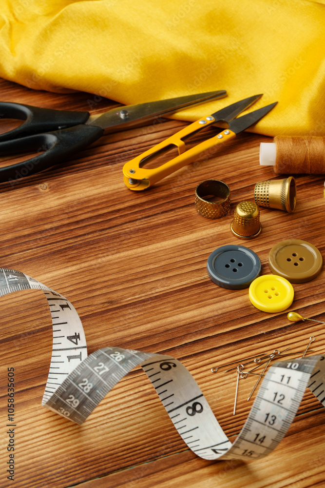 Crafting tools and materials arranged on a wooden table for sewing projects Crafting tools and materials arranged on a wooden table for sewing projects