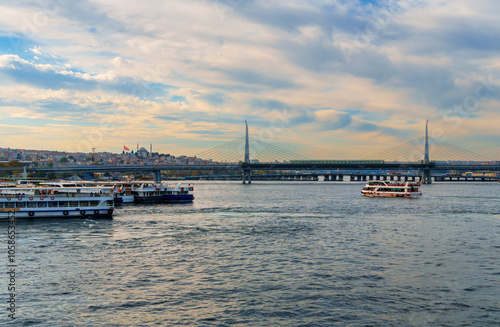 cityscape of Istanbul, Turkey, view to the Golden Horn Bay and architecture of city and ships and Bosphorus shore against the sunset sky, a popular tourist destination