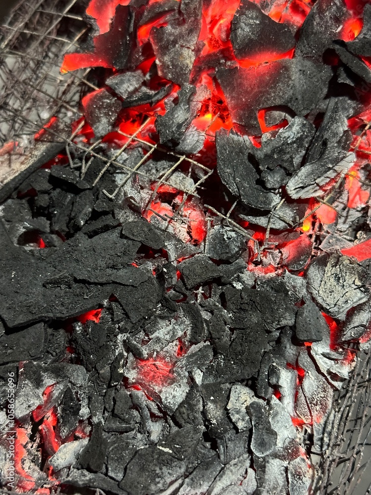Handheld shot of charcoal in brazier, preparation for bbq Handheld shot of charcoal in brazier, preparation for bbq
