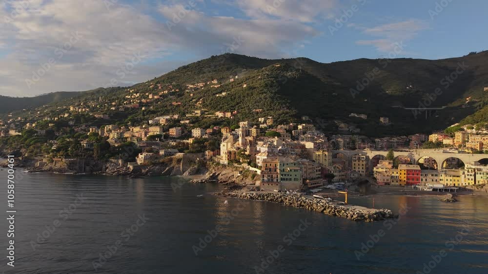 Italian seaside village at sunset with colorful houses, calm waters, and surrounding green hills Italian seaside village at sunset with colorful houses, calm waters, and surrounding green hills
