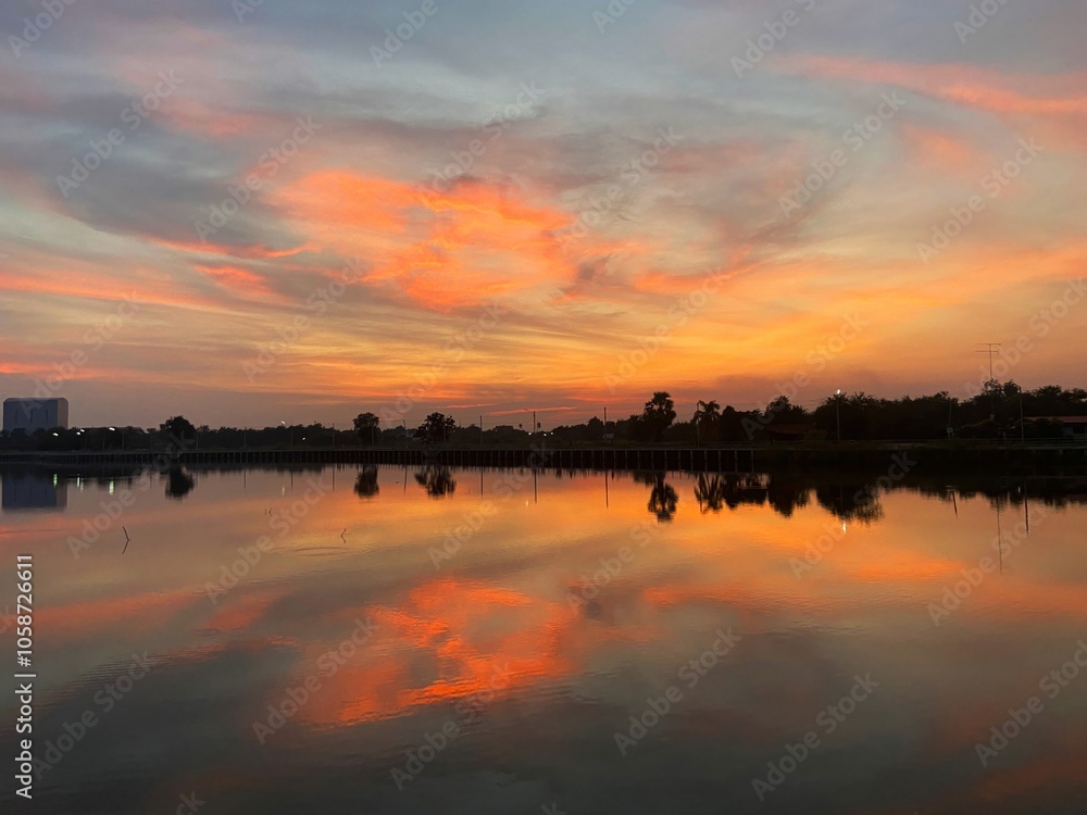 Beautiful evening sky with sunset reflecting on the calm water surface. Beautiful evening sky with sunset reflecting on the calm water surface.