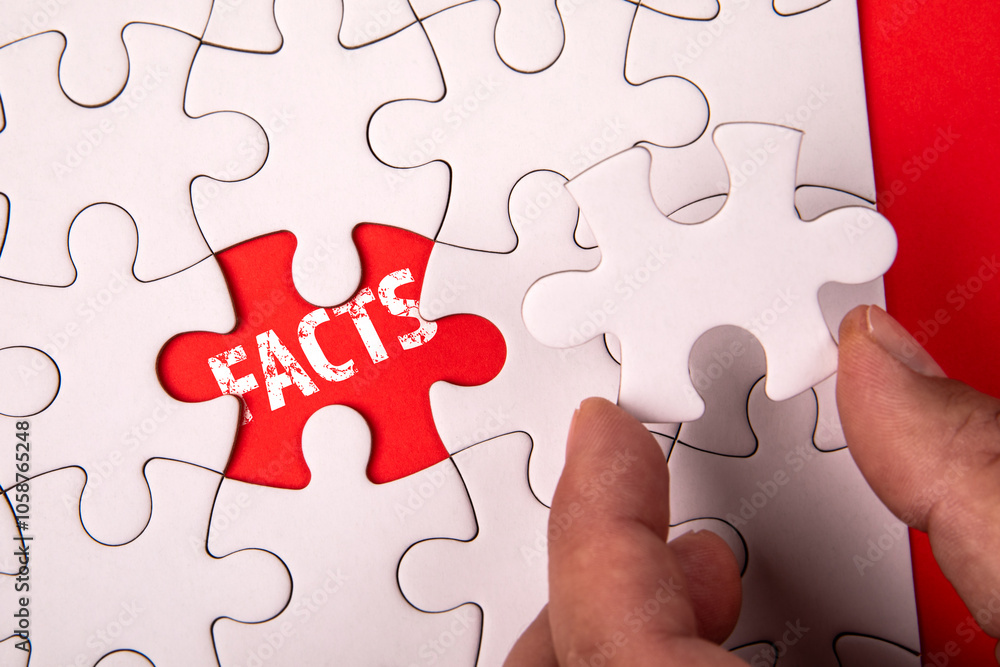 FACTS. White puzzle pieces on an red background FACTS. White puzzle pieces on an red background