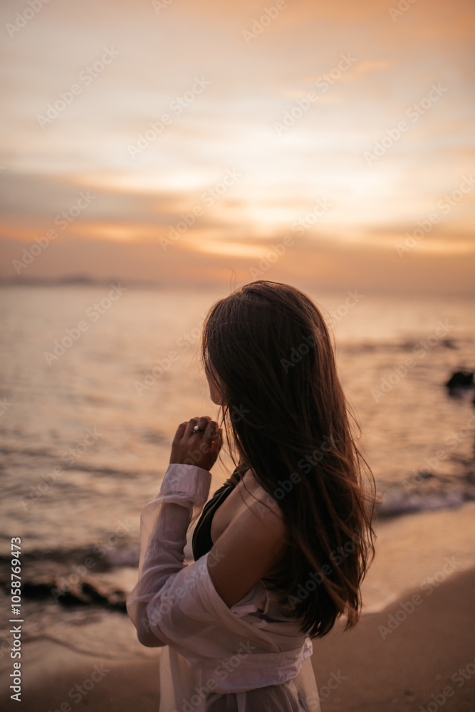 woman on the beach at sunset woman on the beach at sunset
