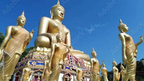 A large golden Buddha statue and many others