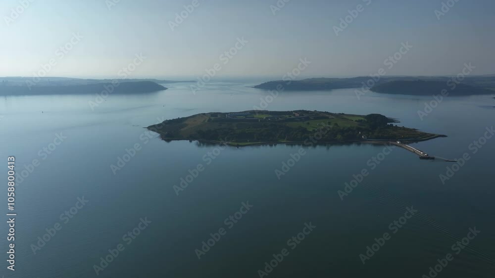 Spike Island, County Cork, Ireland, September 2024. Drone approaches Fort Mitchel as soft hazy light diffuses through clouds of vegetated island prison. Spike Island, County Cork, Ireland, September 2024. Drone approaches Fort Mitchel as soft hazy light diffuses through clouds of vegetated island prison.