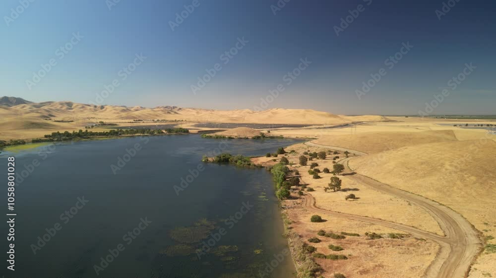 Flying over the San Luis Reservoir, the drone showcases expansive landscapes and winding shorelines. Flying over the San Luis Reservoir, the drone showcases expansive landscapes and winding shorelines.