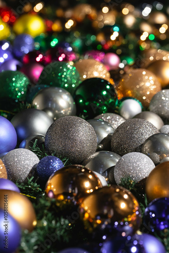 New Year Christmas balls and decorations close up. A lot of decoration of golden, blue, yellow, white, silver. Christmas balls lie on surface. Festive beautiful colorful background.