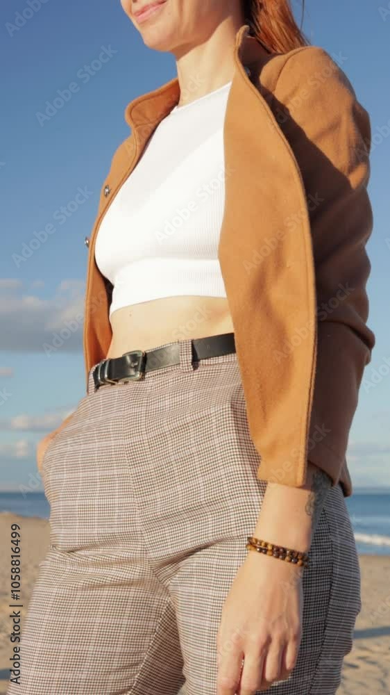 Businesswoman confidently posing in stylish corporate outfit on sunny beach