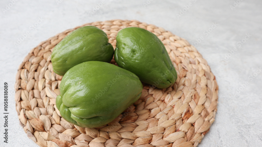 Fresh chayote (Sechium edulis) or labu siamon wicker matt background. Fresh chayote (Sechium edulis) or labu siamon wicker matt background.