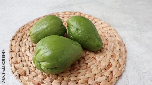 Fresh chayote (Sechium edulis) or labu siamon wicker matt background. photo