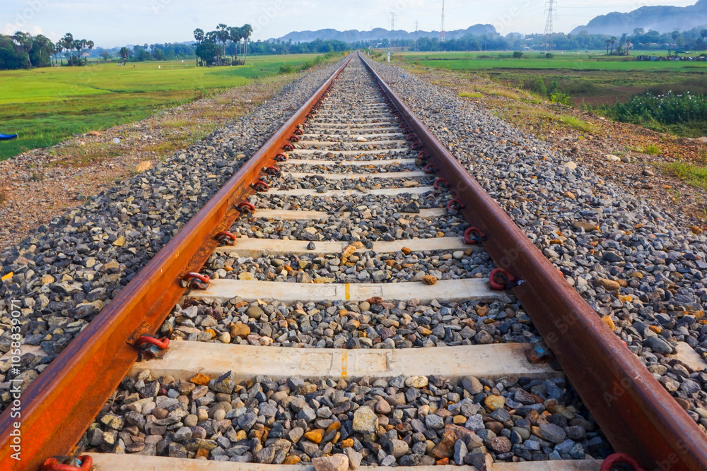 Naklejka premium The view of the train tracks in the morning in rural Indonesia creates a romantic atmosphere
