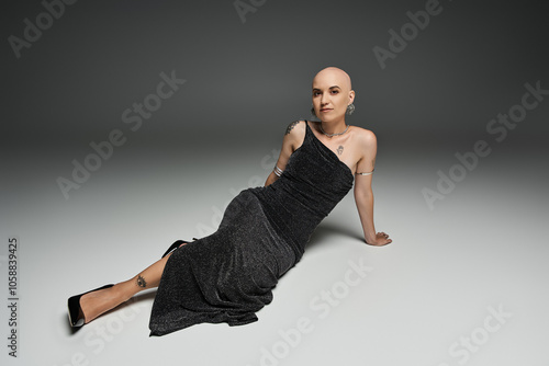 Canvas-taulu A young bald woman with alopecia poses gracefully, showcasing her confidence and elegance