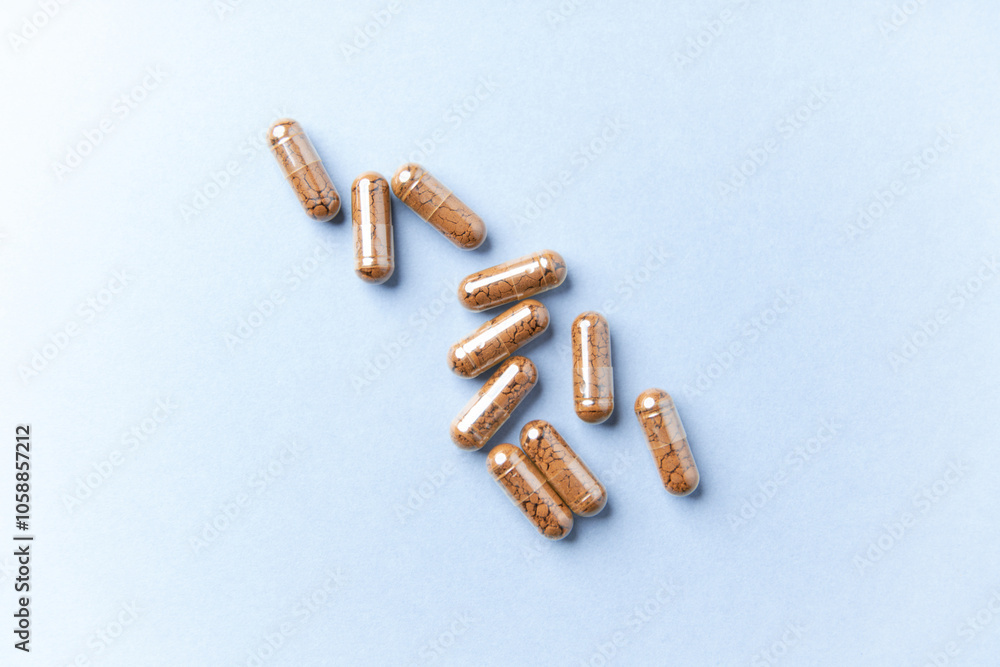 Ashwagandha (Withania somnifera) capsules. Paper background. Soft focus. Close up. Copy space. Ashwagandha (Withania somnifera) capsules. Paper background. Soft focus. Close up. Copy space.