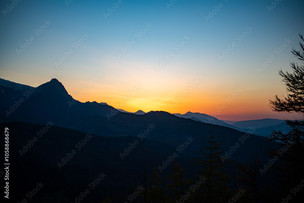 The sunset atop Mount Kopieniec in Zakopane, Poland, casts a warm glow over the Tatra Mountains, creating a stunning landscape The sunset atop Mount Kopieniec in Zakopane, Poland, casts a warm glow over the Tatra Mountains, creating a stunning landscape