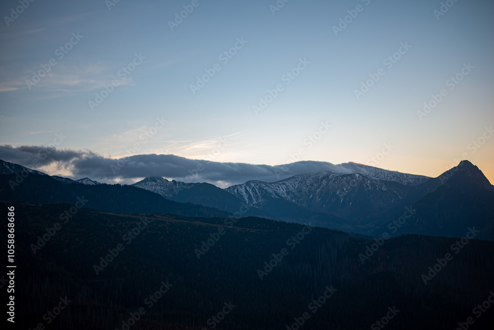 The sunset atop Mount Kopieniec in Zakopane, Poland, casts a warm glow over the Tatra Mountains The sunset atop Mount Kopieniec in Zakopane, Poland, casts a warm glow over the Tatra Mountains