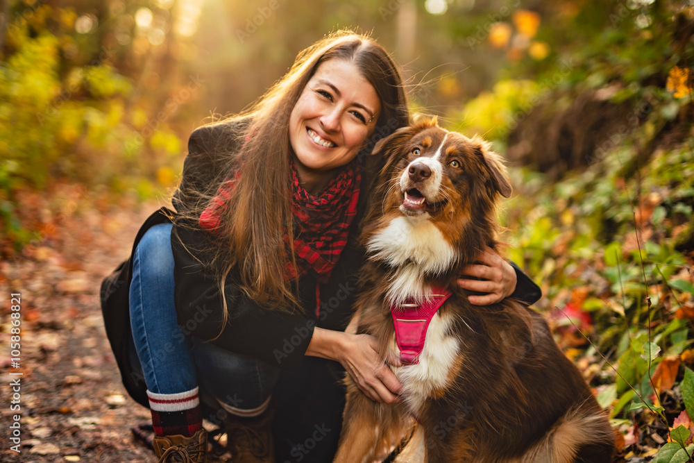 Loving young woman with her shepherd Australian on fall season Loving young woman with her shepherd Australian on fall season