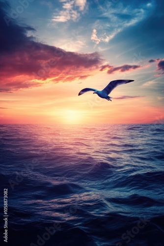 Seagull flying over ocean at sunset