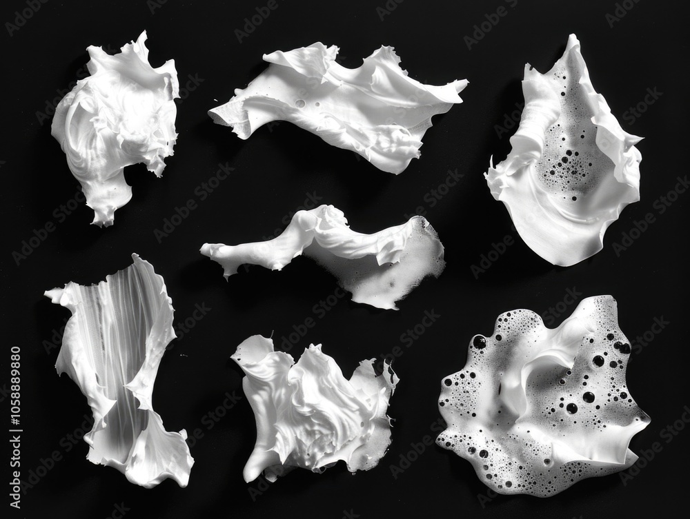 A collection of variously shaped seashells on a black surface, possibly used for jewelry or decoration. A collection of variously shaped seashells on a black surface, possibly used for jewelry or decoration.