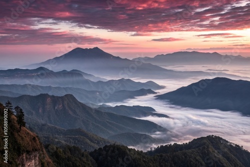 A majestic mountain range at dawn, with misty clouds and a maroon-colored sunrise, mountain range, natural scenery, geography, hillside