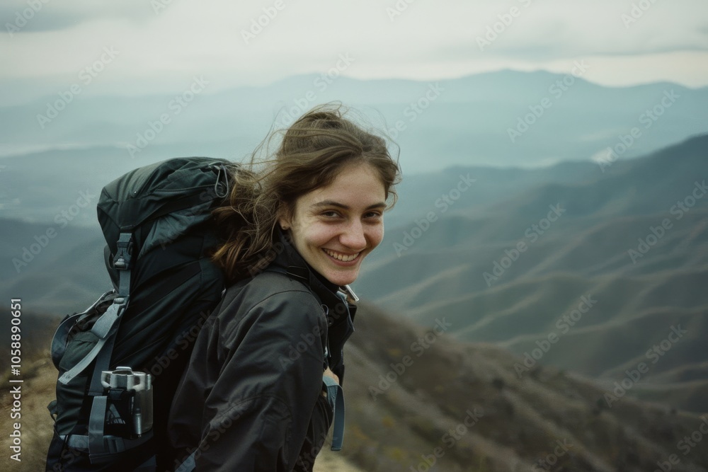 A smiling hiker stands on a mountain ridge, exhilarated by the sweeping view of misty valleys below, symbolizing adventure and the joy of nature. A smiling hiker stands on a mountain ridge, exhilarated by the sweeping view of misty valleys below, symbolizing adventure and the joy of nature.