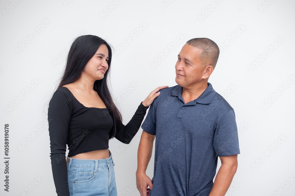 A supportive young asian woman gives reassuring and encouraging pep talk to her dad or uncle. Isolated on a white background. A supportive young asian woman gives reassuring and encouraging pep talk to her dad or uncle. Isolated on a white background.