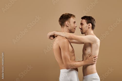 A young couple shares a tender embrace, celebrating their love in a cozy, intimate atmosphere.