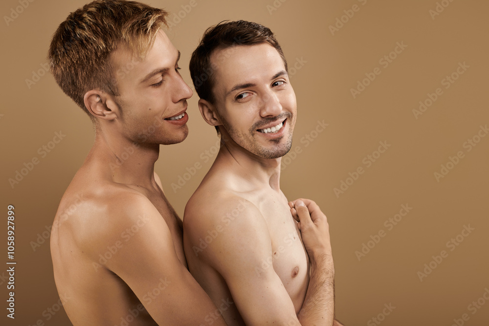 A loving embrace unfolds between two young men, radiating joy and connection in their closeness. A loving embrace unfolds between two young men, radiating joy and connection in their closeness.
