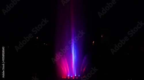 Wallpaper Mural A vibrant LED-lit fountain show with colorful jets of water dancing against a dark background, creating a mesmerizing night spectacle. Torontodigital.ca