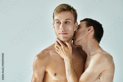 A young couple enjoys a tender kiss while embracing each other in a warm, intimate moment.