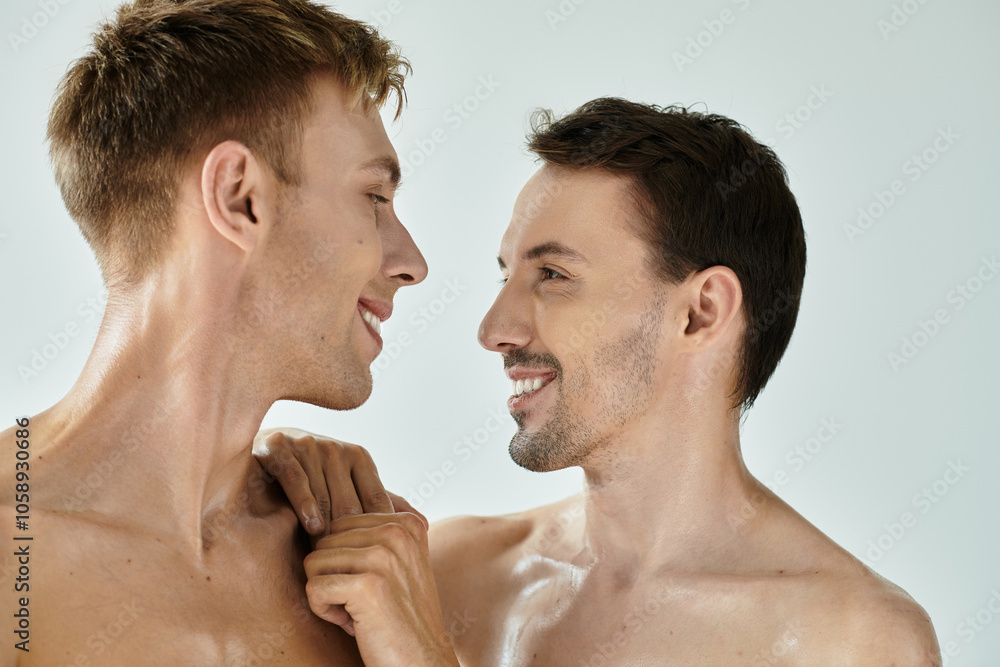 Fototapeta premium Two young men gaze into each others eyes, radiating love and connection in a minimalist space.