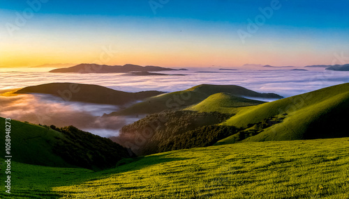 Endless clear and smooth horizon over green hills with fog at the foot in the evening light
