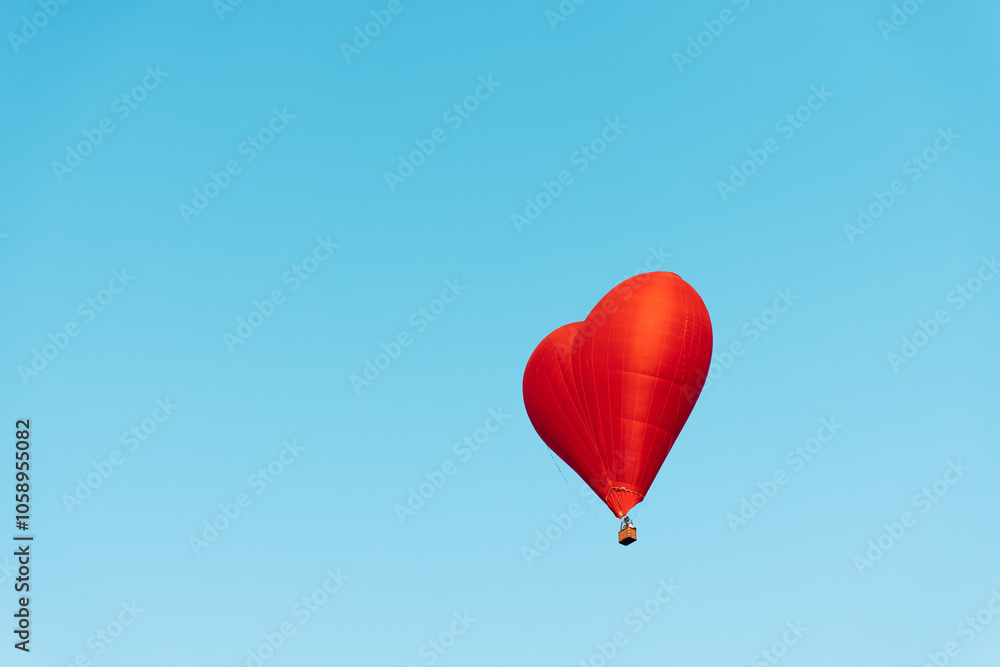 love is in the air red heart shaped balloon soaring in the blue sky with room for your message love is in the air red heart shaped balloon soaring in the blue sky with room for your message
