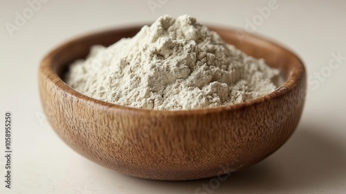 soft beige powder in a bowl set against a clean white background, showcasing the fine texture and subtle hues. the image emphasizes simplicity and purity, ideal for cosmetic or culinary uses