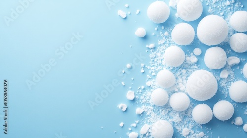 White round polystyrene snowballs on a blue backdrop with ample space for text