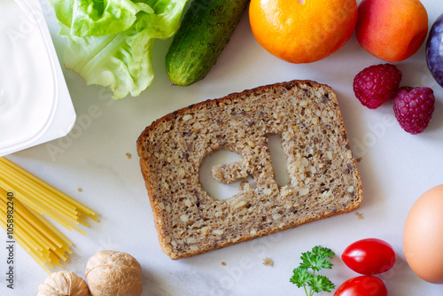 Slice of whole grain bread with symbol GI cut out, products with low glycemic index, creative concept