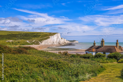Fototapeta The Seven Sisters Chalk cliffs and the coastguard cottages during a early summer day, Seaford, East Sussex, England