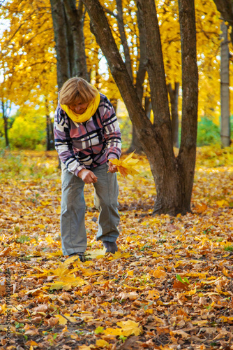 Senior woman in autumn park. Selective focus.