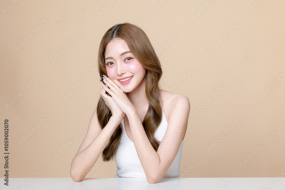Young Asian beauty woman curly long hair with korean makeup style touch her face and perfect skin on isolated beige background. Facial treatment, Cosmetology, plastic surgery. Young Asian beauty woman curly long hair with korean makeup style touch her face and perfect skin on isolated beige background. Facial treatment, Cosmetology, plastic surgery.