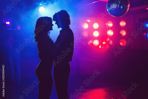 Silhouette of a couple in a discotheque under disco ball, retro photo from 1980s photo