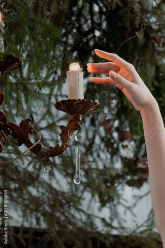 hand touches the candle photo