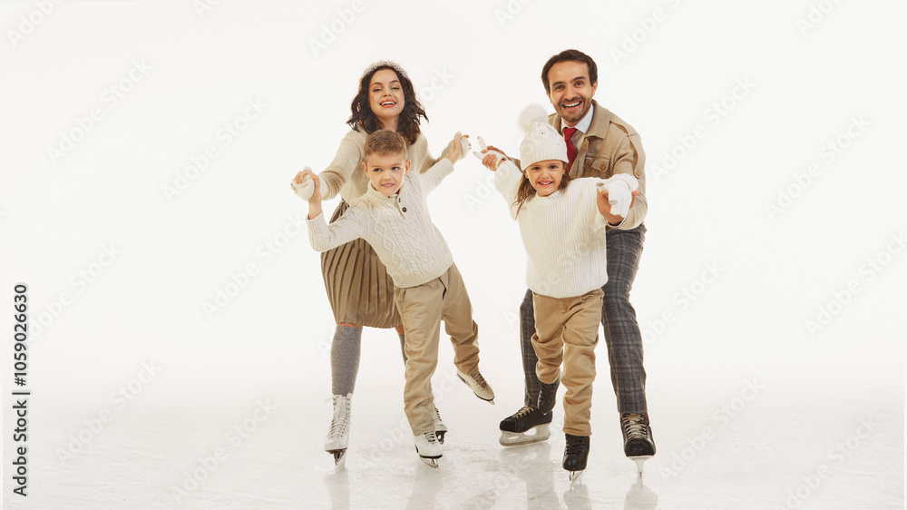 Joyful happy family spending good time with kids, boy and girl. All four dressed in warm stylish winter clothes. Laughter and joy. Concept of winter, vacation, holiday, leisure activity Joyful happy family spending good time with kids, boy and girl. All four dressed in warm stylish winter clothes. Laughter and joy. Concept of winter, vacation, holiday, leisure activity