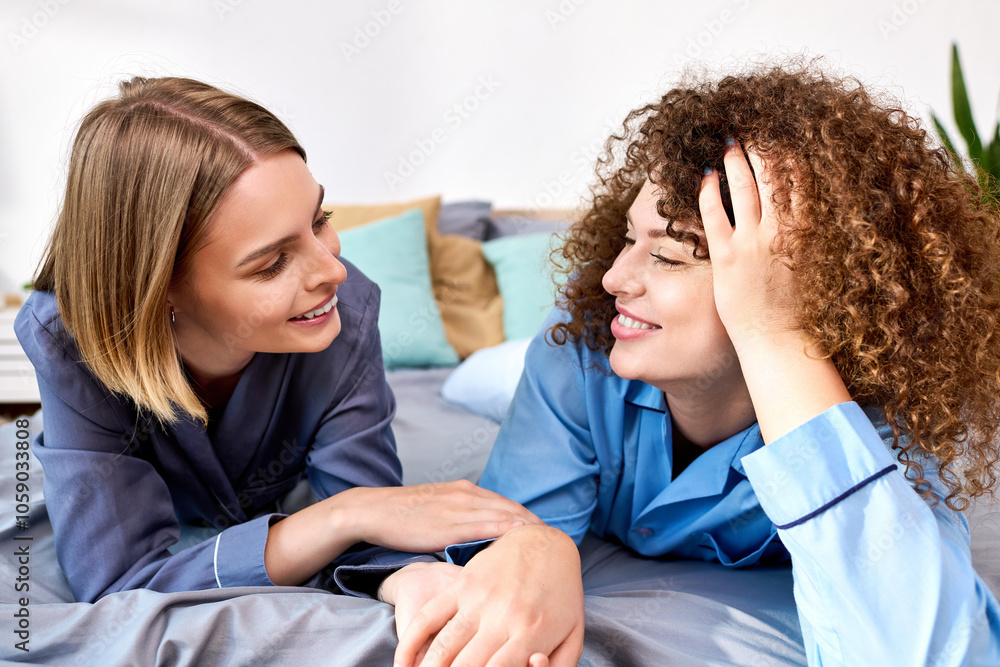 A joyful couple shares laughter and affection while lounging on their bed, embracing intimacy. A joyful couple shares laughter and affection while lounging on their bed, embracing intimacy.